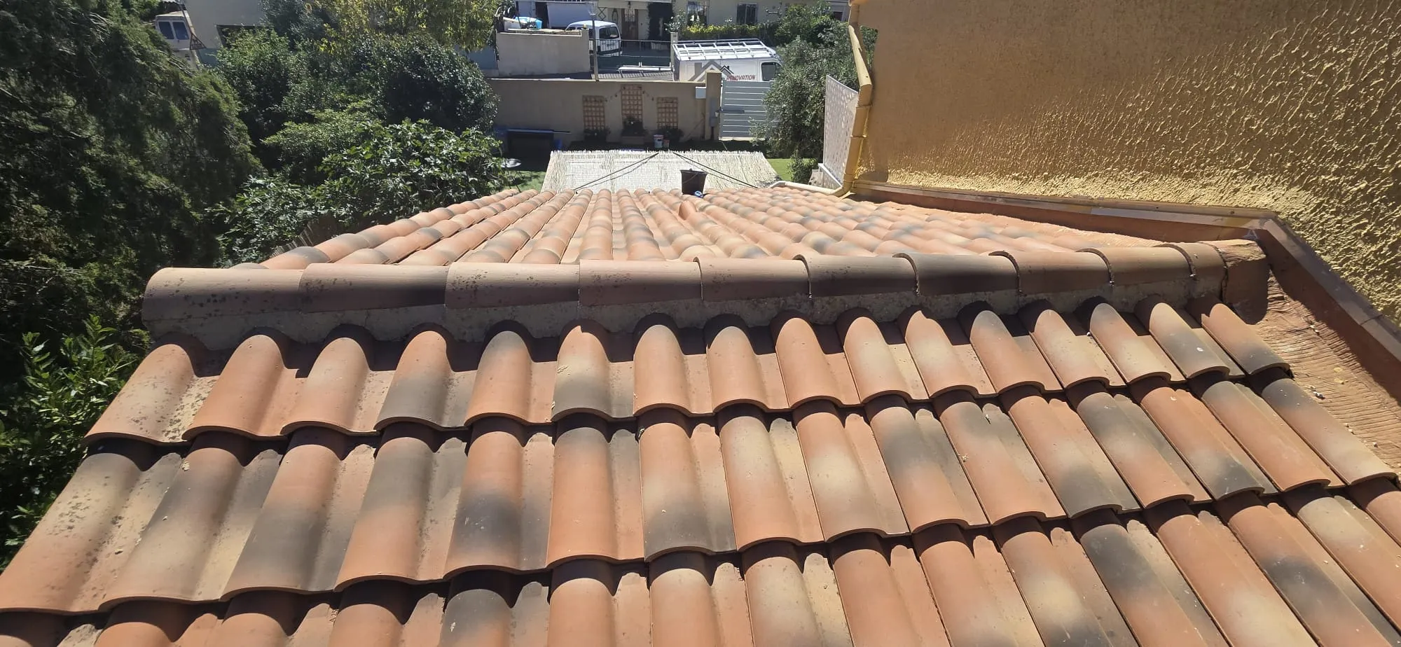 Couvreur intervenant sur la toiture d'un immeuble ancien à Toulon